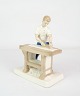 Hand-painted 
porcelain 
figurine with a 
motif of a man 
using a planer 
no. 21816
H: 19.5cm W: 
14.5cm
