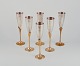 Swedish 
designer. A set 
of six 
champagne 
glasses in 
brass and 
silver-plated 
brass. ...