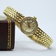 Omega; A ladies 
wristwatch of 
14k gold. Chain 
14k gold 
L. 17,8 cm. W. 
5 - 7 mm. 
Watch ...