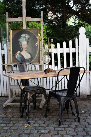 Old French bistro table with black iron base and old wooden top...
