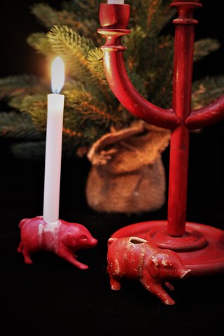 Small, old pigs in red-painted porcelain with a small hole in the back for a 
small Christmas light...