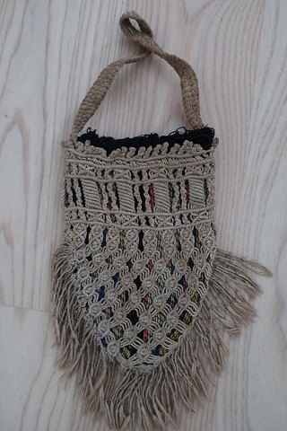 An antique beautiful handbag handmade of flax, and it has the characteristic colour of  flax The closing is made with a string, handmade as well