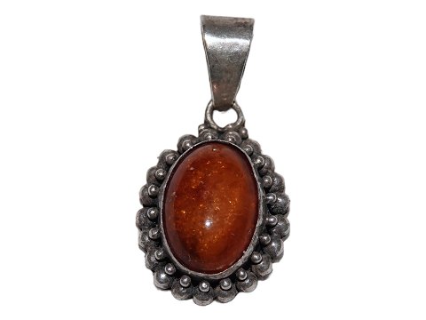 Small amber pendant with silver mounting