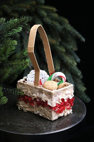 Antique Christmas tree ornament from around 1920 in the shape of a Christmas 
basket made of cardboard and tissue paper.