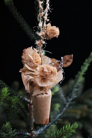 Old Christmas tree ornament from around 1940 in the shape of a small potted 
plant made of cardboard and paper.