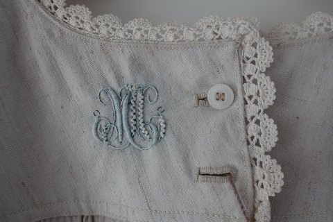 Særk / kjole af hør
Antik særk med korte ærmer og med de rigtige trekanter i ærmegabet
Særken er med håndbroderet knaphuller, håndbroderede initialer, håndhæklede 
kanter samt anden pynt. 
Hørstoffet gør den vidunderlig at have på
Antikt, dansk linned