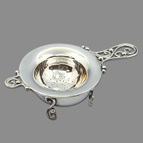 A Danish tea strainer of in sterling silver A Danish tea strainer of in sterling silver