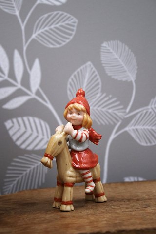 Royal Copenhagen Pixie in porcelain, no.180 - girl riding on a straw buggy.