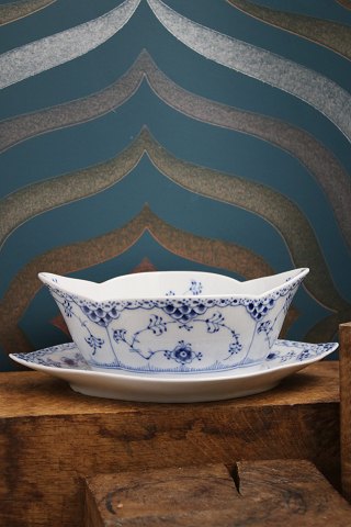 Boat-shaped sauce bowl on a solid saucer in Blue Fluted Half Lace from Royal Copenhagen...