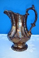 English pitcher, copper colored luster decorated with flowers, height 17 cm. Fine condition