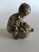 Royal 
Copenhagen 
Stoneware 
Figurine of a 
child with a 
bear No 20245. 
Measures 11cm 
and is in ...