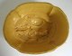 Pudding 
mould in glazed 
ceramics. 
Yellow, with 
conical sides, 
with bottom 
motif in the 
form of ...
