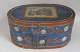 Wig 
box,&nbsp;Germany, 
19th century. 
Blue, red and 
white painted 
with rose 
pattern. On the 
cover ...
