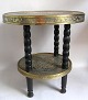 Chinese tea table 20 C. With 4 turning black painted legs with 2 brass plates decorated with ...
