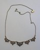 Necklace with 
grenades, c. 
1900, 36 
grenades, L. 43 
cm. With lock 
in 18 K gold.