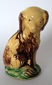 Piggy bank in 
the form of 
seated dog, 
Bornholm, 19th 
century. 
Yellowish, 
brown and green 
glaze. ...