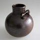 Nakajima, 
Yoshio (1940 - 
) 
Sverige/Japan: 
Vase. Brun 
saltglasur. H.: 
10,5 cm. 
Signeret.: 
Yoshio.