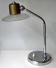 German table 
lamp in chromed 
metal, around 
1950. Round 
base with 
switch. Bent 
light arm with 
...