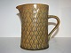 Kronjyden 
Relief 
stoneware, milk 
pitcher.
Designed by 
Jens Harald 
Quistgaard.
Height 14 ...