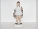 Bing & Grøndahl 
Figurine, girl 
taking blue 
coat off.
The factory 
mark shows, 
that this was 
...