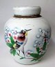 Chinese lidded 
vase o. 1900, 
porcelain, with 
polychrome 
decoration in 
the form of 
bird on a ...