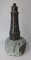 Granite 
sculpture in 
the shape of a 
lighthouse on a 
rock, 19th 
century. 
Lighthouse in 
polished ...