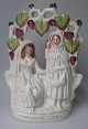 Staffordshire 
earthenware 
figure, 19th 
century. 
Fortune Teller. 
Women under 
vine leaves. 
Cream ...