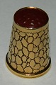 Gold timble 
with red stone 
on the top. 
Beautifully 
decorated 
around the 
timble. Gold 
mark inside ...
