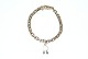 Anchor chain 
Facet bracelet 
with pendant 
"R" Gold, 14 
karat
Stamped: 585 
FL
Goldsmith: ...