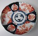 Japanese Imari 
plate, 19th 
century. With 
wavy edge and 
polychrome 
decoration with 
vegetation. On 
...