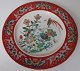 Famille rose 
plate in 
porcelain, 
China, 19th 
century. Red 
border 
decoration with 
flowers. Mirror 
...