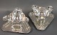 A pair of silver gravy boats on the feet and  on a triangular silver tray.
5000 m2 showroom.