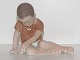 Bing & Grondahl 
figurine, boy 
sitting.
The factory 
mark shows, 
that this was 
made between 
...