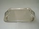 Holger Kyster 
Tray Silver 
(830). Length 
28 cm. Handle 
in mussel form. 
There are four 
small pins ...