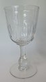 Clear drinking 
glass on foot, 
with olive 
grindings, c. 
1910, Denmark. 
H: 18.5 cm. 
(Pt. 5 ...