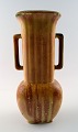 Gunnar Nylund, 
Rörstrand vase 
in ceramic.
Rare form.
Beautiful 
glaze in shades 
of brown.
In ...