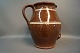 Large brown 
ceramic jug 
with white 
stripes.
H: 31,5 cm and 
Dia: 19 cm.