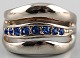 Silver ring 
with blue 
stones.
Size: 19 mm.
Not stamped.
In very good 
condition.
