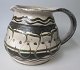 Herman A. 
Kähler milk 
jug, 1920 1930, 
Næstved, 
Denmark. Over 
glazes in 
cream, black 
and green. H 
...