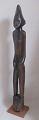 African wood figure of a naked man. 20th century. H .: 81 cm. On a square foot.