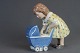 Porcelain 
Figure: Girl 
with baby 
buggy, h: 16 cm