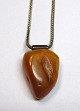 Polished amber 
pendant. 
Denmark. With 
sterling chain. 
Length chain: 
42 cm. Weight 
amber: 6.2 ...