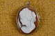Cameo adorable 
woman's head 
cut off conch, 
mounted in 
scalloped 
silver frame. 
The piece is 
both ...