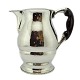 Cohr, water jug 
in lightly 
hammered 
hallmarked 
silver. Cohr, 
Fredericia, 
Denmark, 1927. 
H. 18 cm.