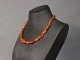 Short amber 
necklace with 
simpel brass 
Lock.
L - 52 cm.