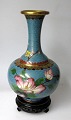 Cloissonne 
vase, China, 
20th century. 
Polychrome 
decoration on 
light blue 
background with 
a bird ...
