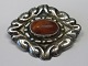 Jugend Brooch 
in silver with 
amber, ca. 1920 
Denmark. 
Stamped .: 
830s. 4.5 x 3.5 
cm. Needle 
missing.