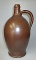 Antique liquor 
bottle, 19th 
century. Brown 
salt glaze. 
Schleswig 
Holstein. With 
handle. H: 28 
cm.