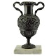 A burnished 
bronze vase on 
marble base. A 
burnished 
bronze vase, 
classic, 
decorated with 
vine ...