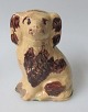 Bornholmsk 
money box, like 
a poodle, 19th 
century. 
Denmark. 
Yellowish and 
brown glazed 
...